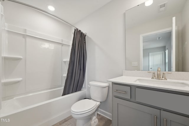 full bathroom featuring vanity, shower / bath combo, and toilet