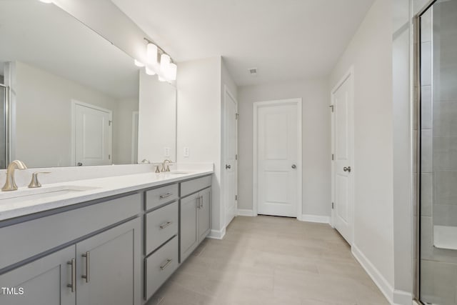 bathroom featuring vanity and a shower with door