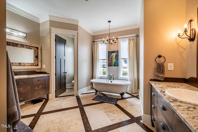 bathroom with vanity, crown molding, a chandelier, and a tub to relax in