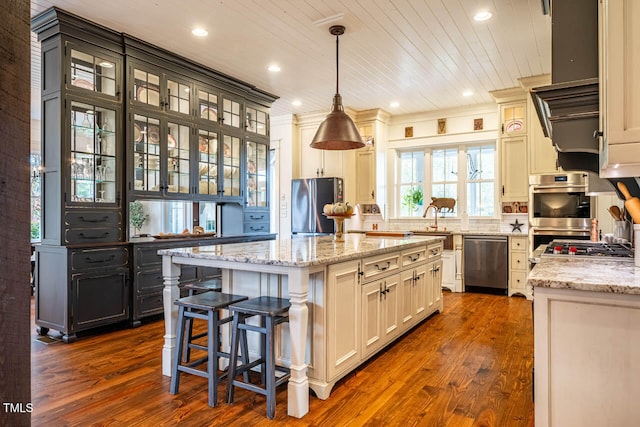 kitchen featuring dark wood-type flooring, hanging light fixtures, stainless steel appliances, a kitchen island, and wooden ceiling