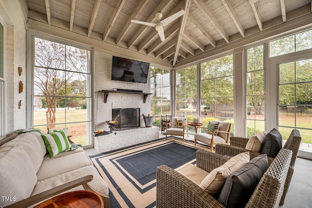 sunroom featuring a brick fireplace, vaulted ceiling with beams, wood ceiling, and ceiling fan