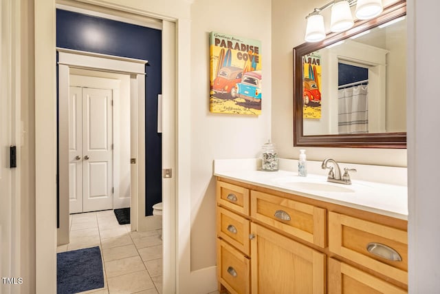 bathroom featuring vanity, toilet, and tile patterned flooring