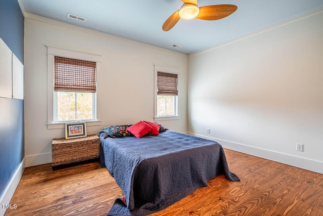 bedroom with wood-type flooring and ceiling fan