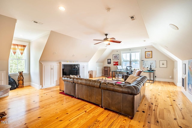 living room with ceiling fan, plenty of natural light, and light wood-type flooring