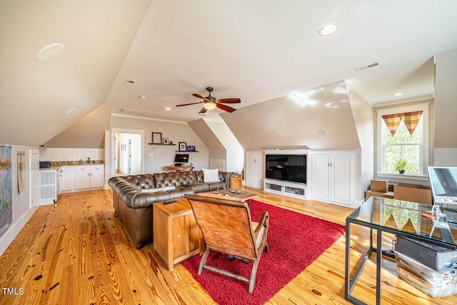 living room featuring vaulted ceiling, ceiling fan, and light hardwood / wood-style floors