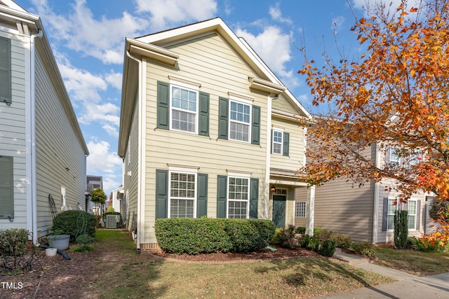 view of front of home featuring central AC and a front lawn