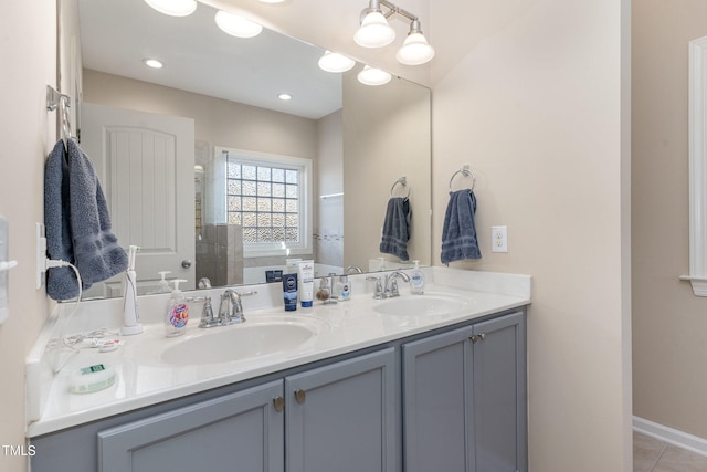 bathroom with vanity, tile patterned flooring, and walk in shower