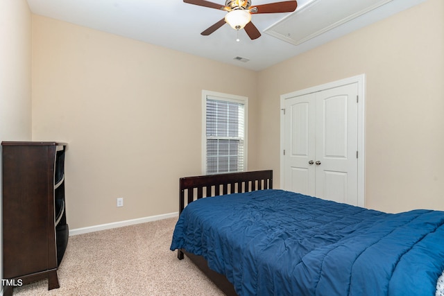 carpeted bedroom featuring a closet and ceiling fan