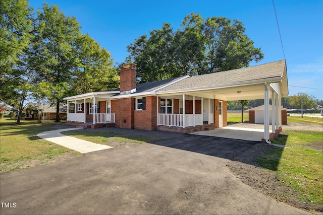 ranch-style house featuring an outdoor structure, a front lawn, covered porch, and a carport