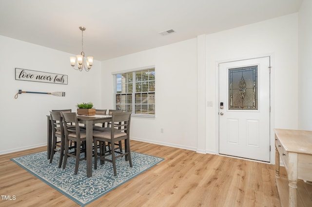 dining room with an inviting chandelier and wood-type flooring