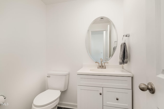 bathroom featuring toilet and vanity