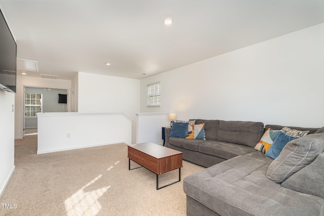 living room featuring light carpet and a wealth of natural light