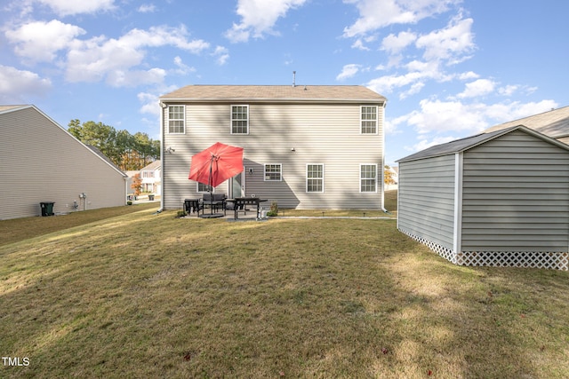 back of house featuring a patio area and a lawn