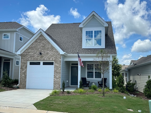 view of front of home with a garage and a front lawn