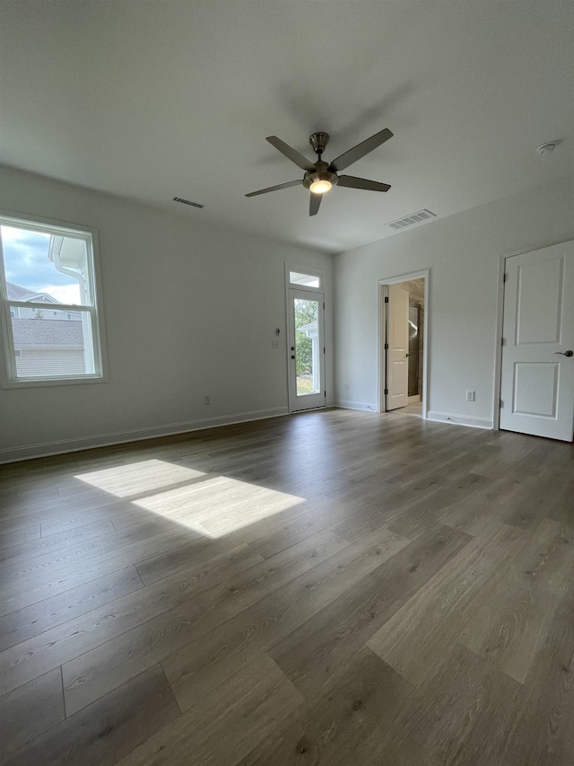 unfurnished room with ceiling fan and wood-type flooring