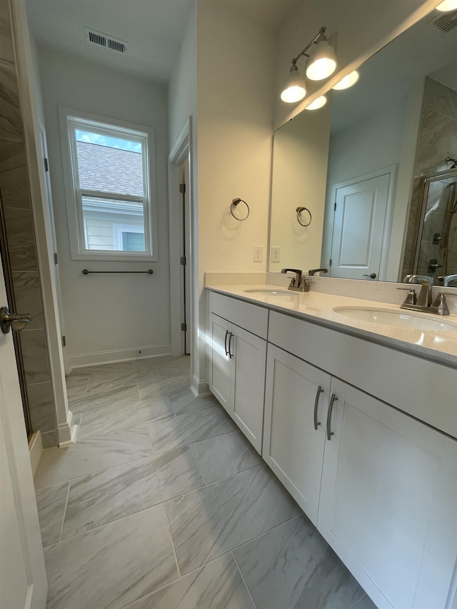 bathroom featuring vanity and an enclosed shower