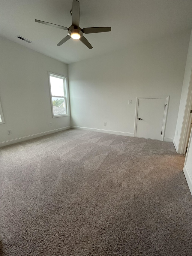 spare room with carpet and ceiling fan