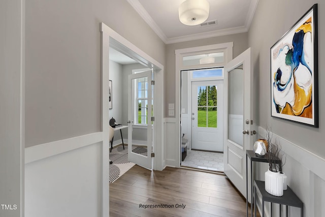 entryway with crown molding and dark hardwood / wood-style floors