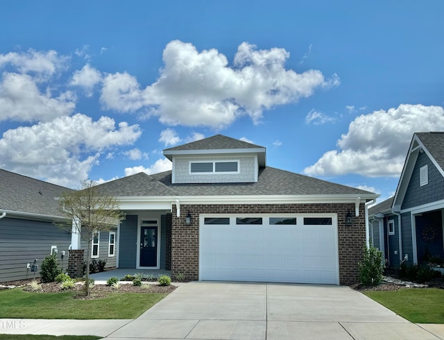 view of front of property featuring a front yard and a garage