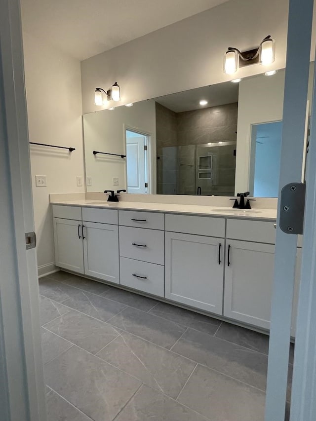 bathroom featuring vanity, tile patterned flooring, and walk in shower