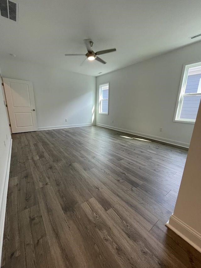 spare room featuring ceiling fan and dark hardwood / wood-style floors