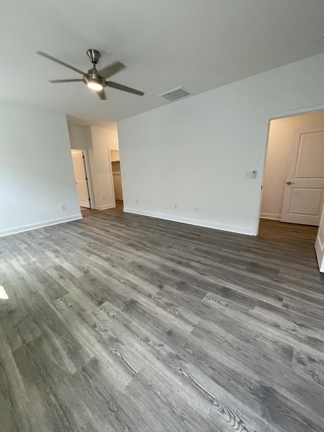 empty room featuring dark hardwood / wood-style floors and ceiling fan