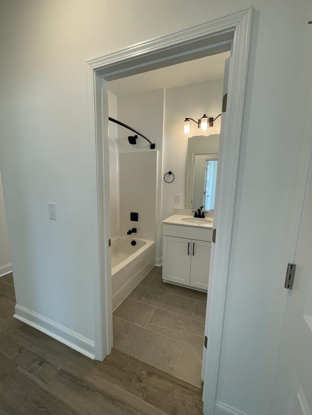 bathroom featuring vanity, bathtub / shower combination, and hardwood / wood-style floors