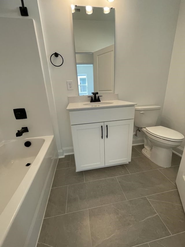 bathroom featuring vanity, toilet, and tile patterned flooring