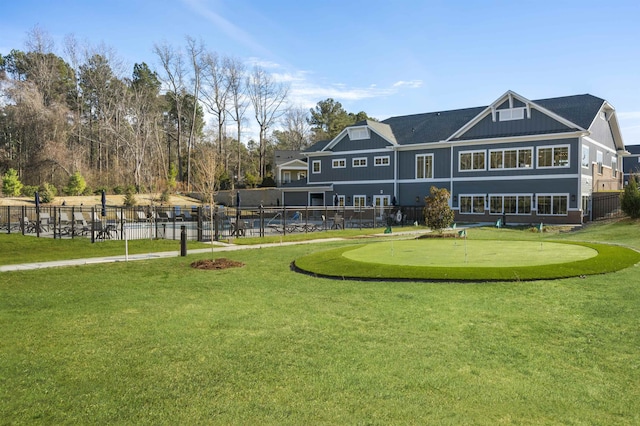 view of home's community with a yard