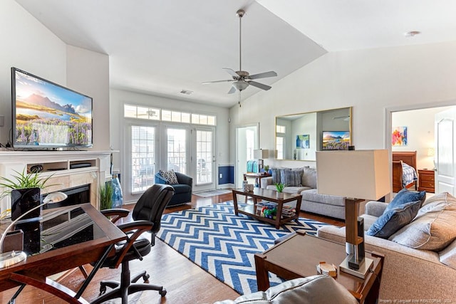 living room with ceiling fan, high vaulted ceiling, and wood-type flooring