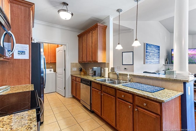 kitchen with washer / dryer, sink, stainless steel appliances, lofted ceiling, and pendant lighting