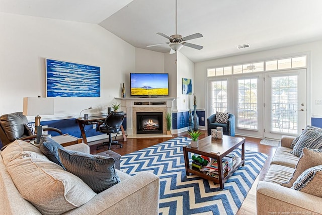 living room with lofted ceiling, hardwood / wood-style flooring, and ceiling fan