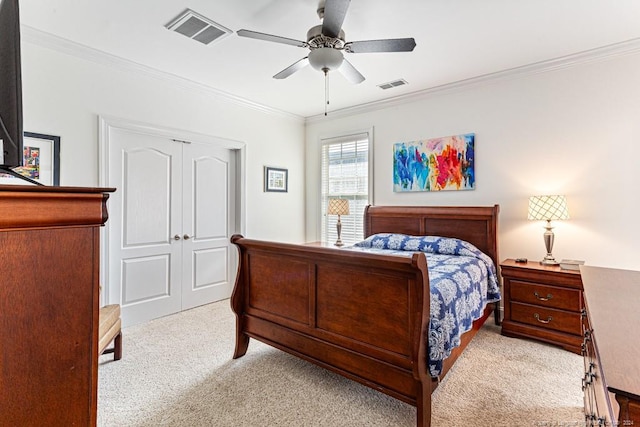 carpeted bedroom with crown molding, a closet, and ceiling fan