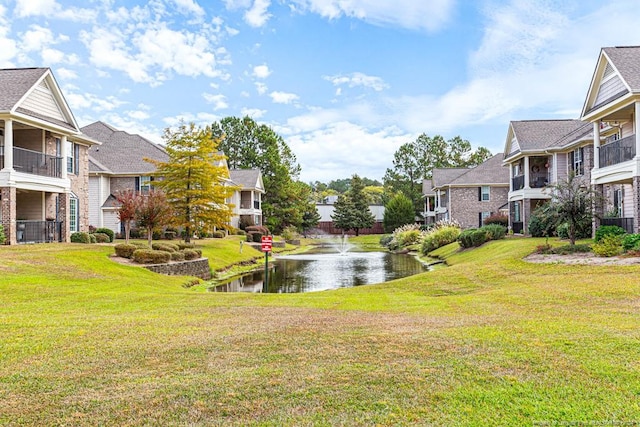 view of yard with a water view and a balcony