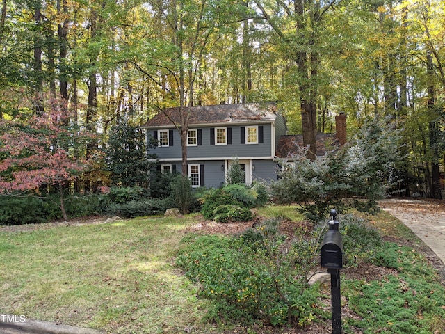 colonial-style house with a front yard