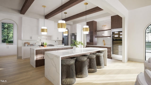 211 Reynolds Rd, Raleigh, NC 27609 - kitchen with a center island, beverage cooler, backsplash, light wood finished floors, and beamed ceiling
