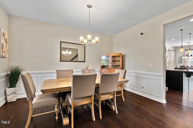 dining space featuring an inviting chandelier and dark hardwood / wood-style floors