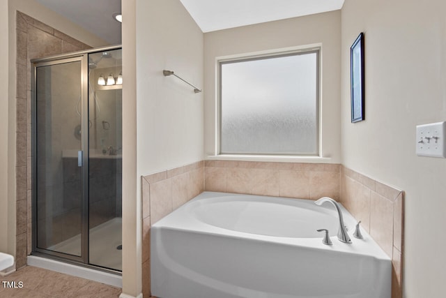 bathroom featuring plus walk in shower and tile patterned floors