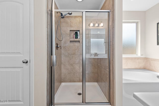 bathroom featuring a shower with shower door