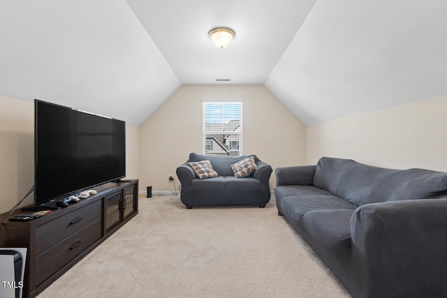 carpeted living room with vaulted ceiling