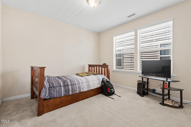 bedroom featuring light carpet