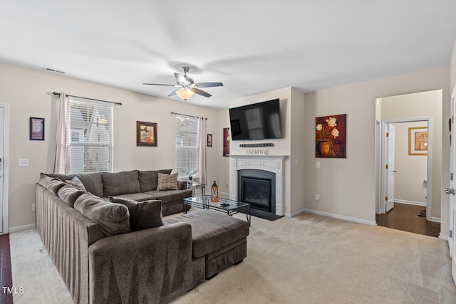 living room with ceiling fan and light colored carpet