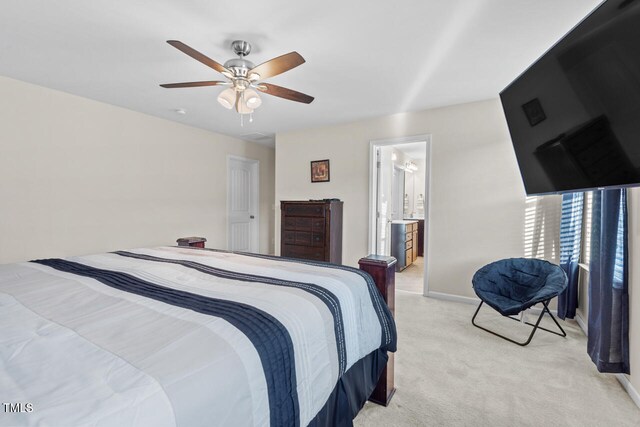 carpeted bedroom featuring ensuite bathroom and ceiling fan