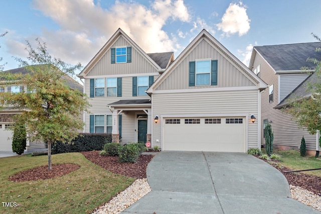 craftsman inspired home with a garage and a front yard