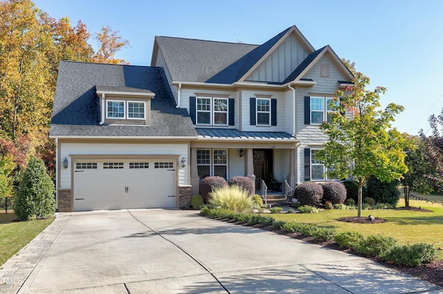 craftsman inspired home with a front lawn, a garage, board and batten siding, a porch, and concrete driveway