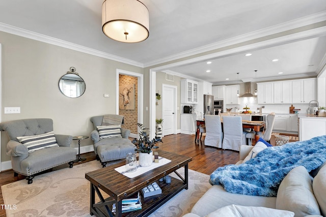 living area with baseboards, ornamental molding, dark wood-style floors, and visible vents