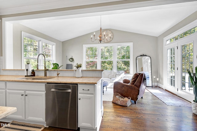 kitchen featuring a healthy amount of sunlight, sink, stainless steel dishwasher, and white cabinets