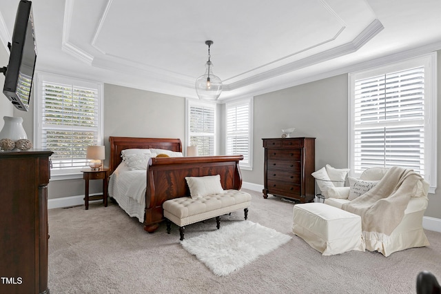 bedroom featuring light colored carpet, ornamental molding, and a tray ceiling