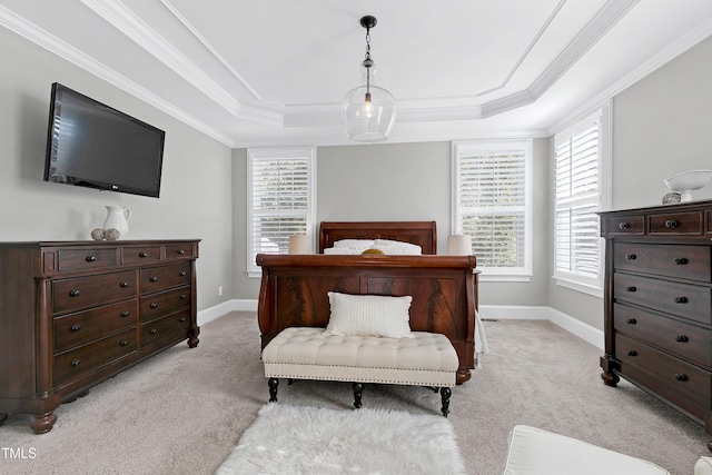 bedroom featuring light colored carpet, ornamental molding, a raised ceiling, and baseboards