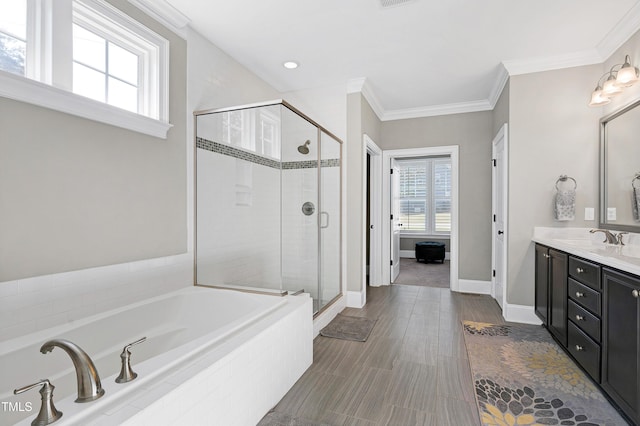 full bath featuring double vanity, a shower stall, a garden tub, and a wealth of natural light